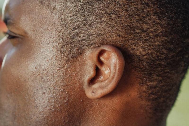 A close shot of a man's head in profile, the focus on his ear.