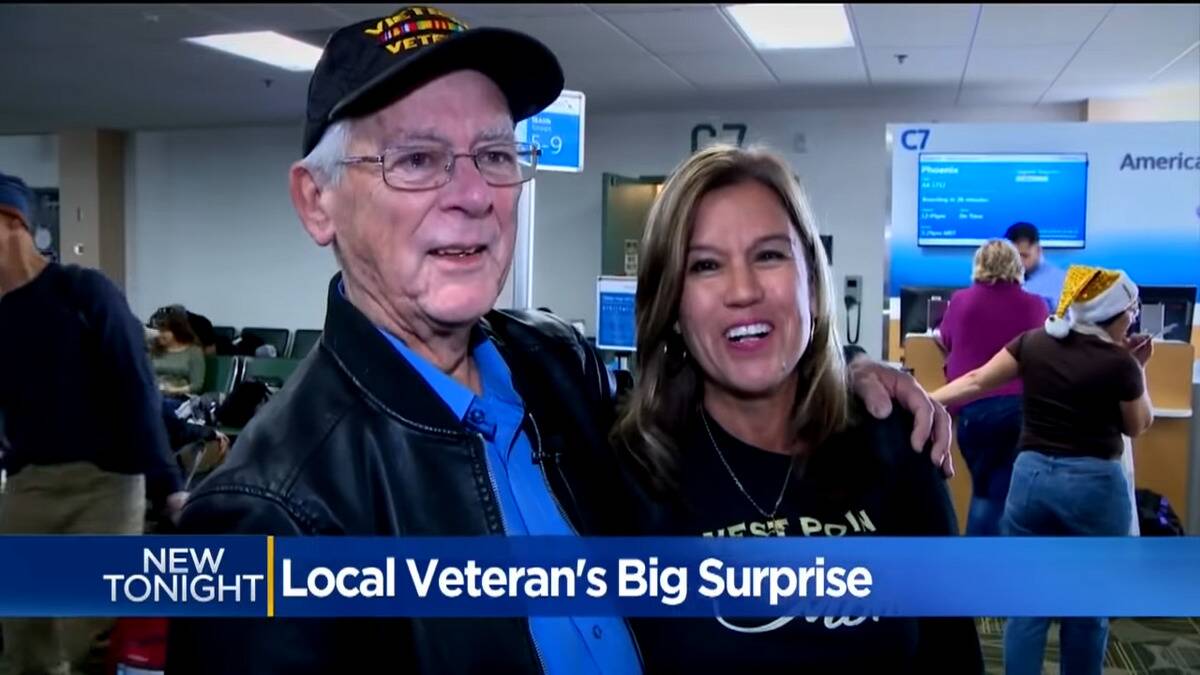 Barnes and Robles meeting at the airport, standing side by side, Barnes' arm around his daughter.