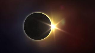 A render of a solar eclipse, a star-shaped glare on the right side.