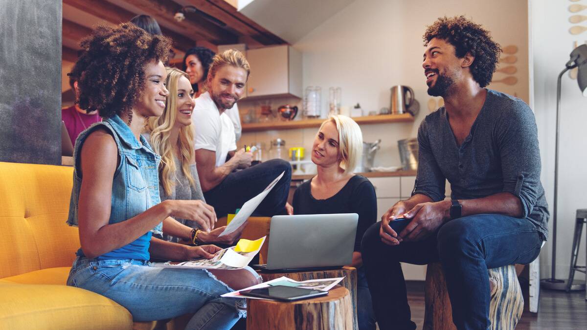 A group of young business people chatting casually.