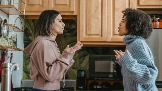 Two friends facing each other, arguing.