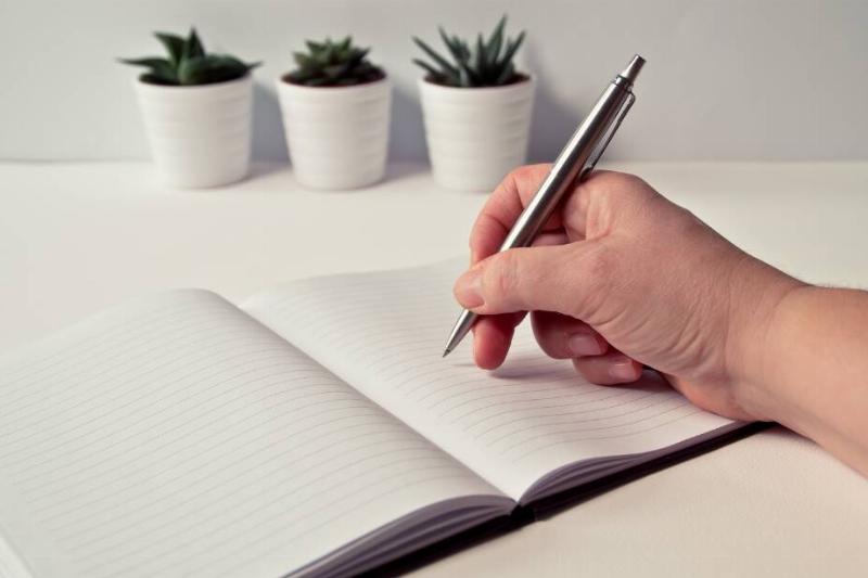 Someone writing down creatively