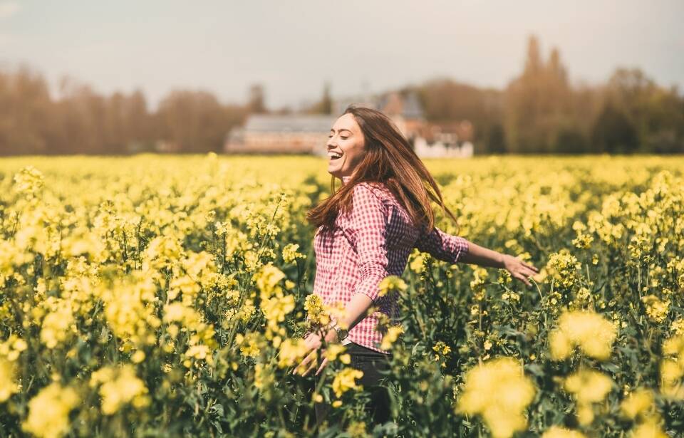 A woman frolicking through a flower field