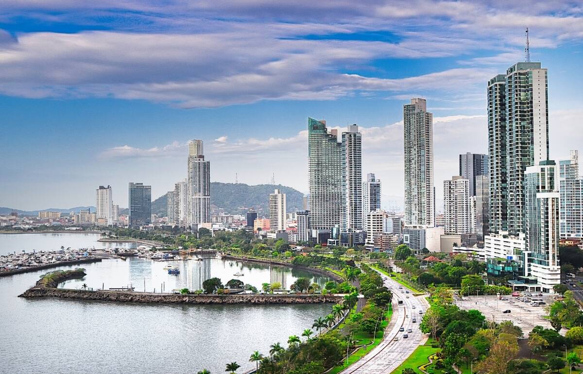 A view of a shoreline in a city in Panama, with beautiful architecture and roads, and a great view of the water