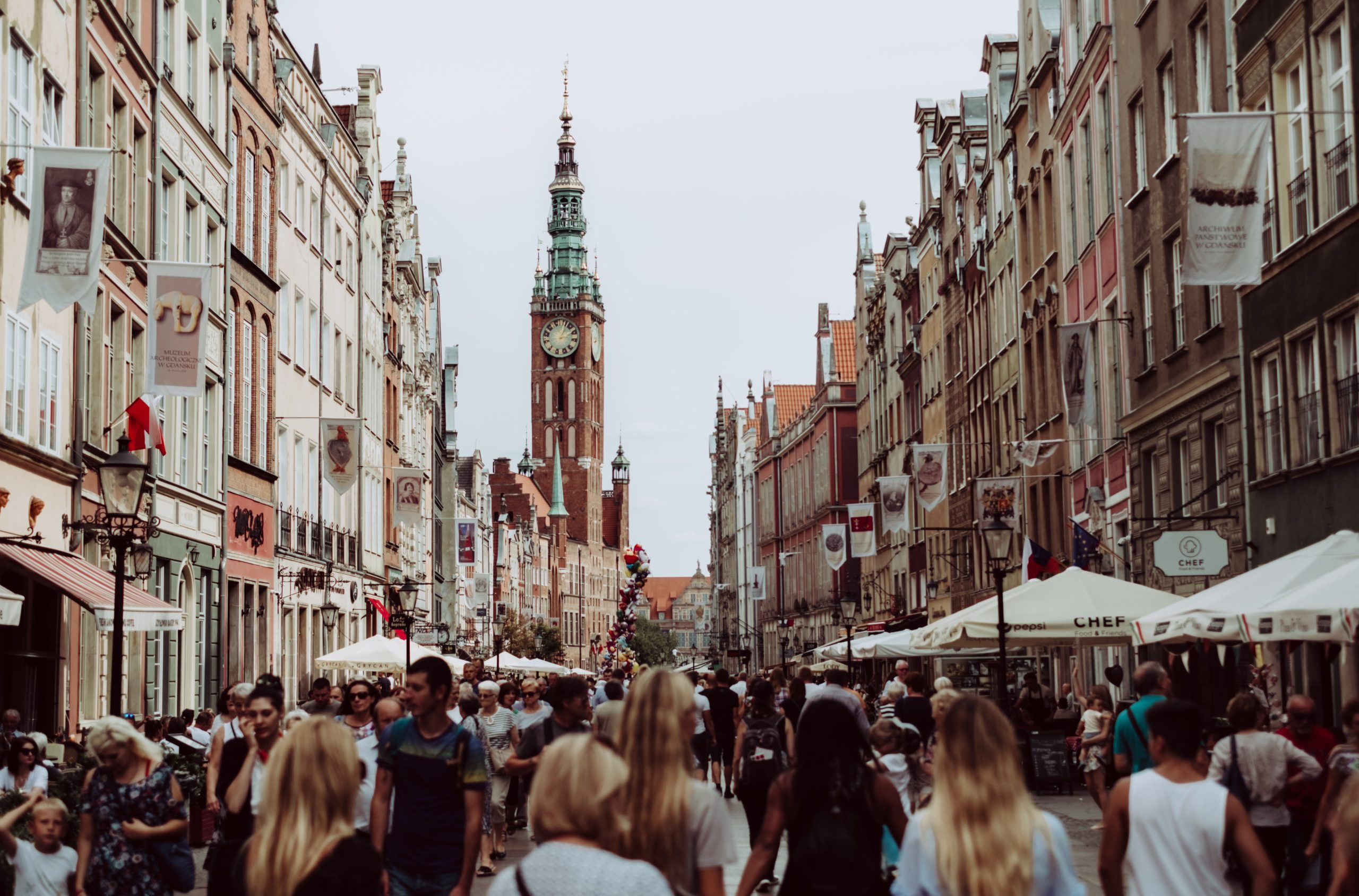 A crowd walking around city streets.