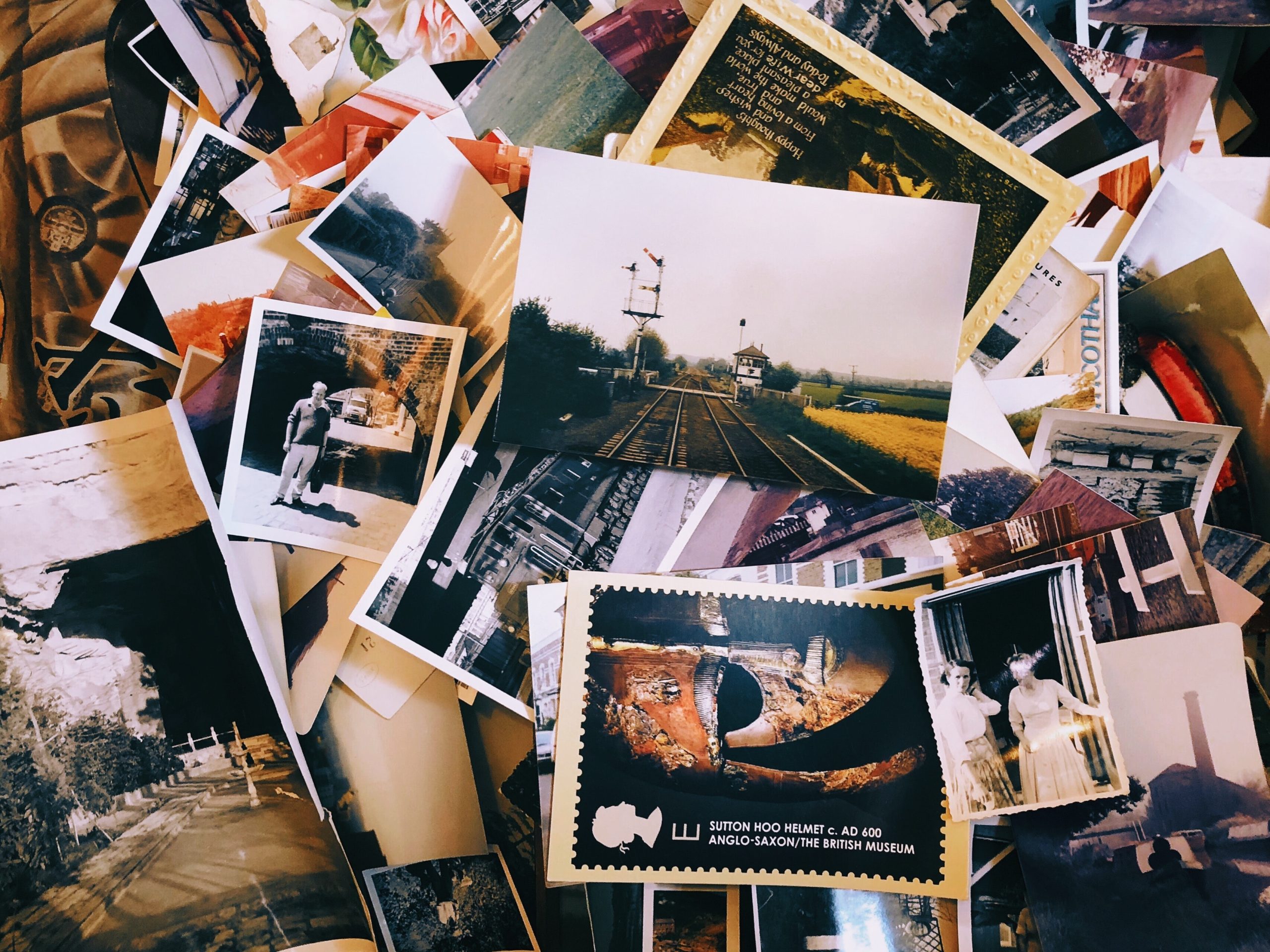 A pile of photographs on a table.