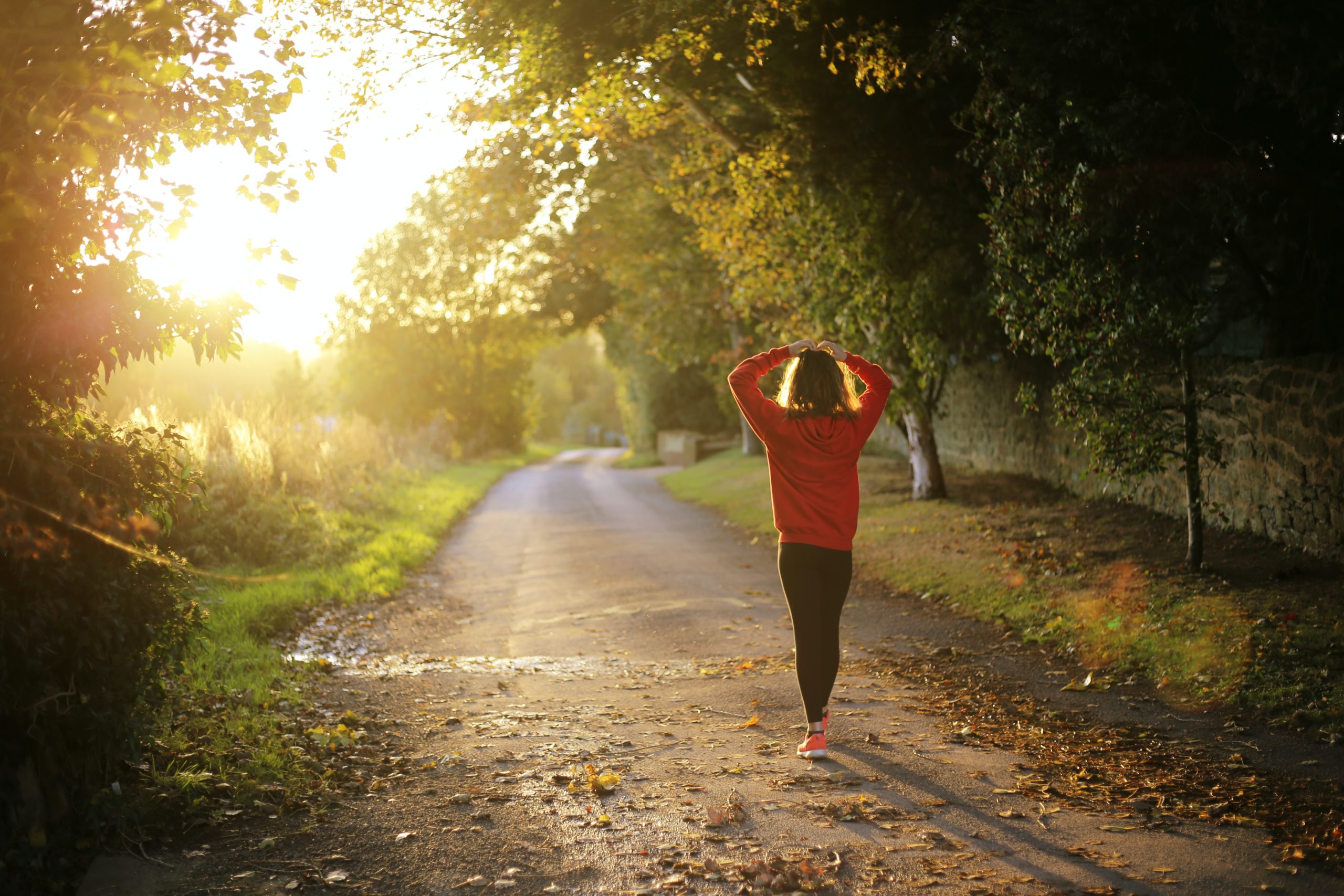 A woman walking along a trail.