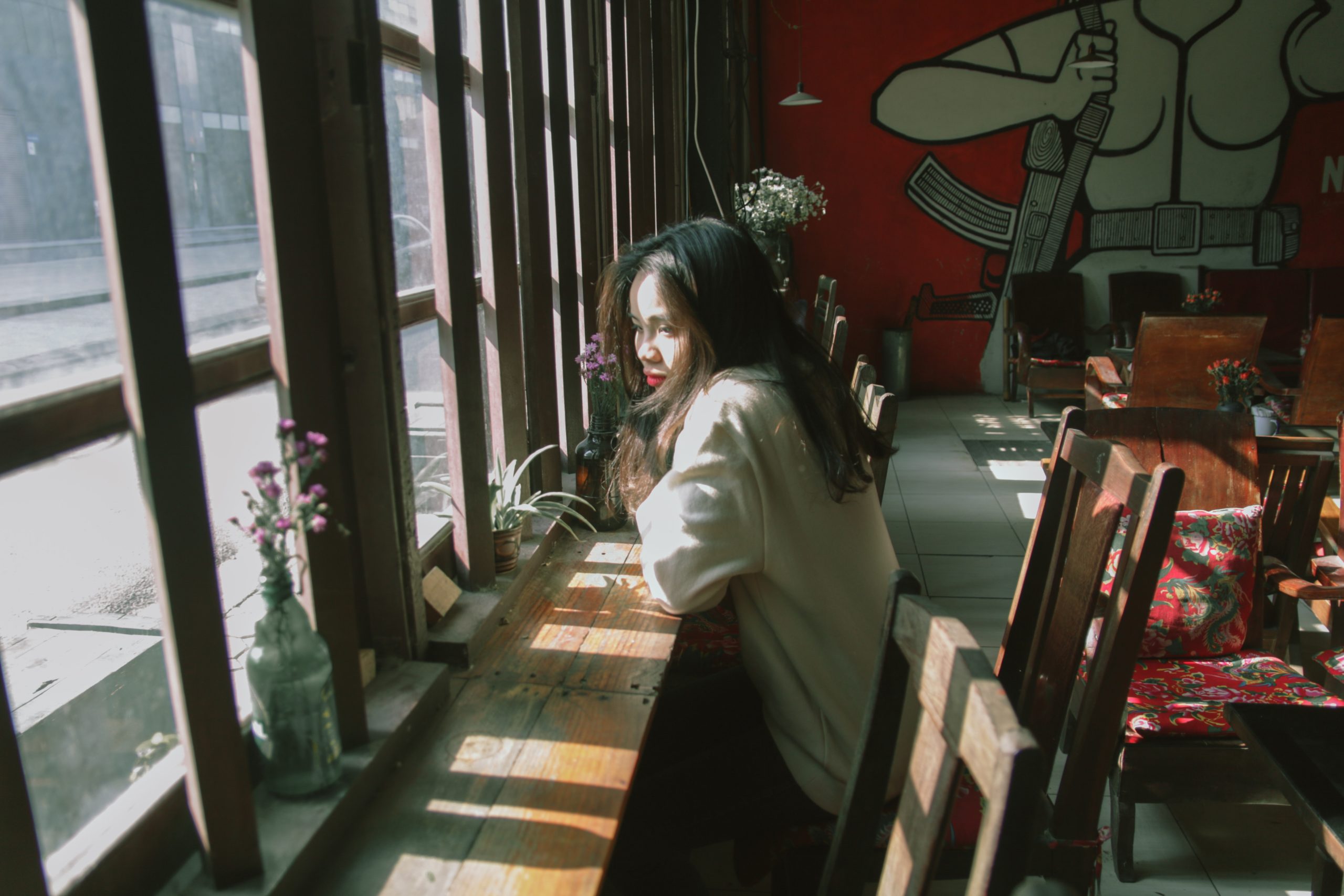 A woman sitting alone in a cafe.