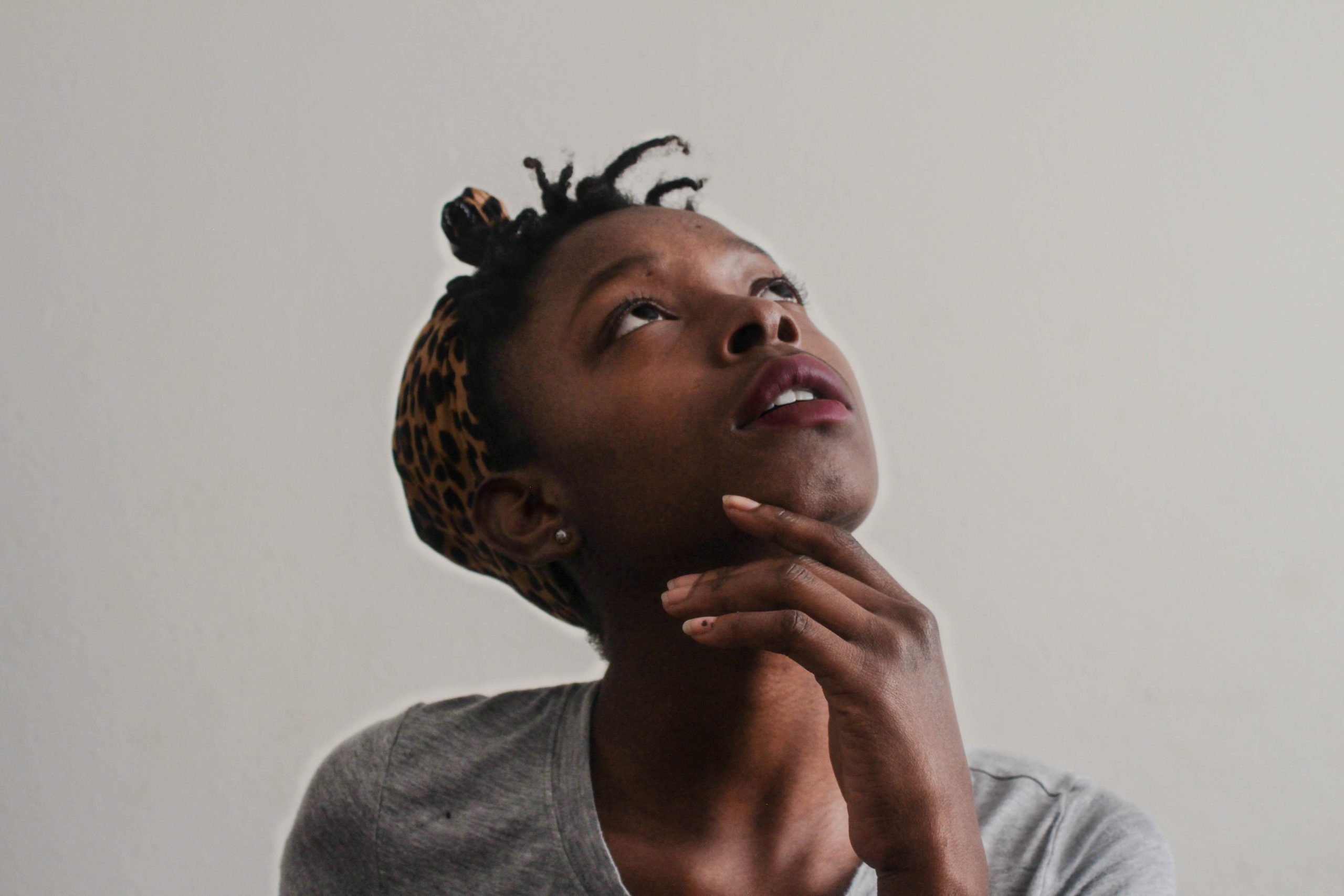 A woman looking upwards in thought.