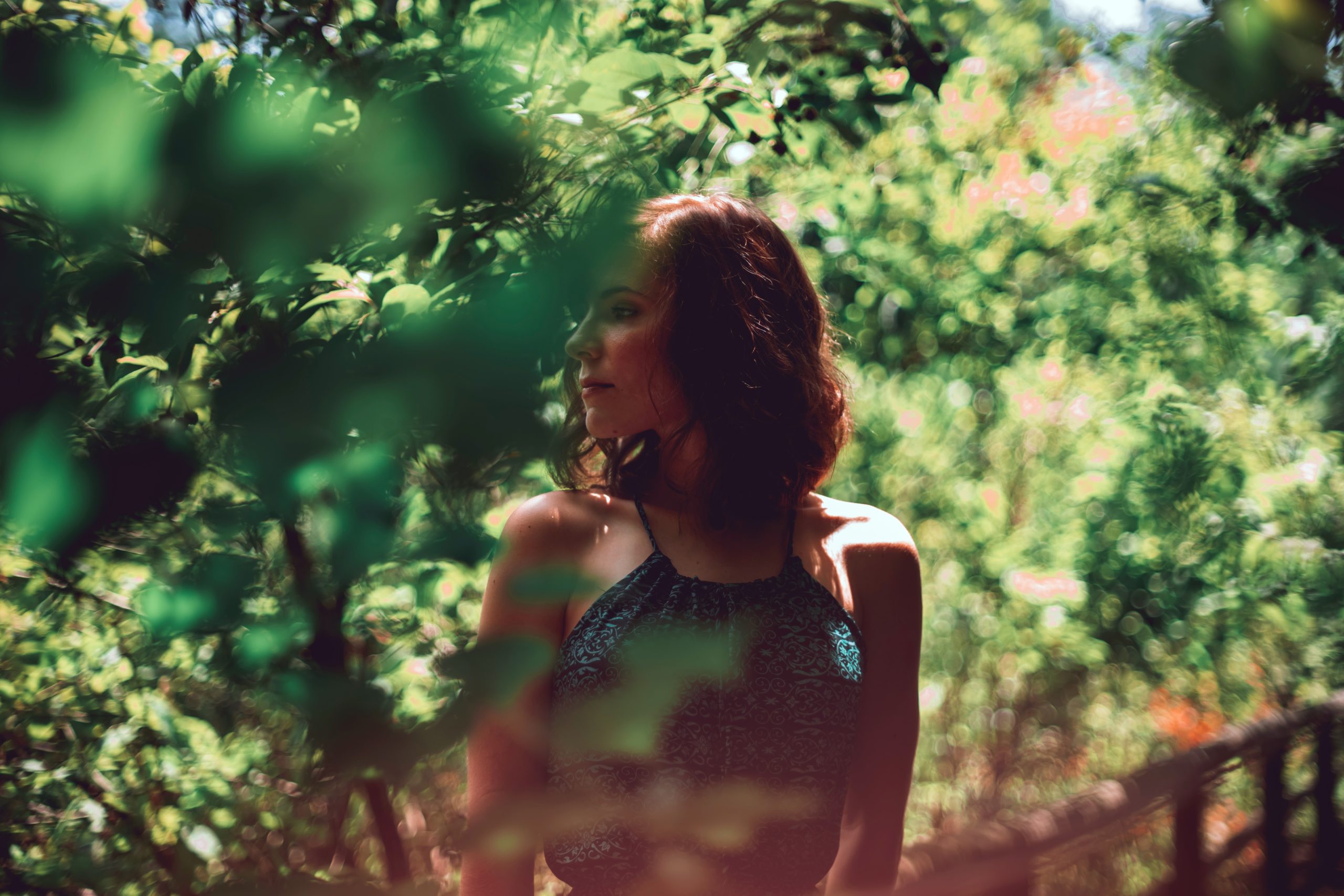 A woman standing among some foliage