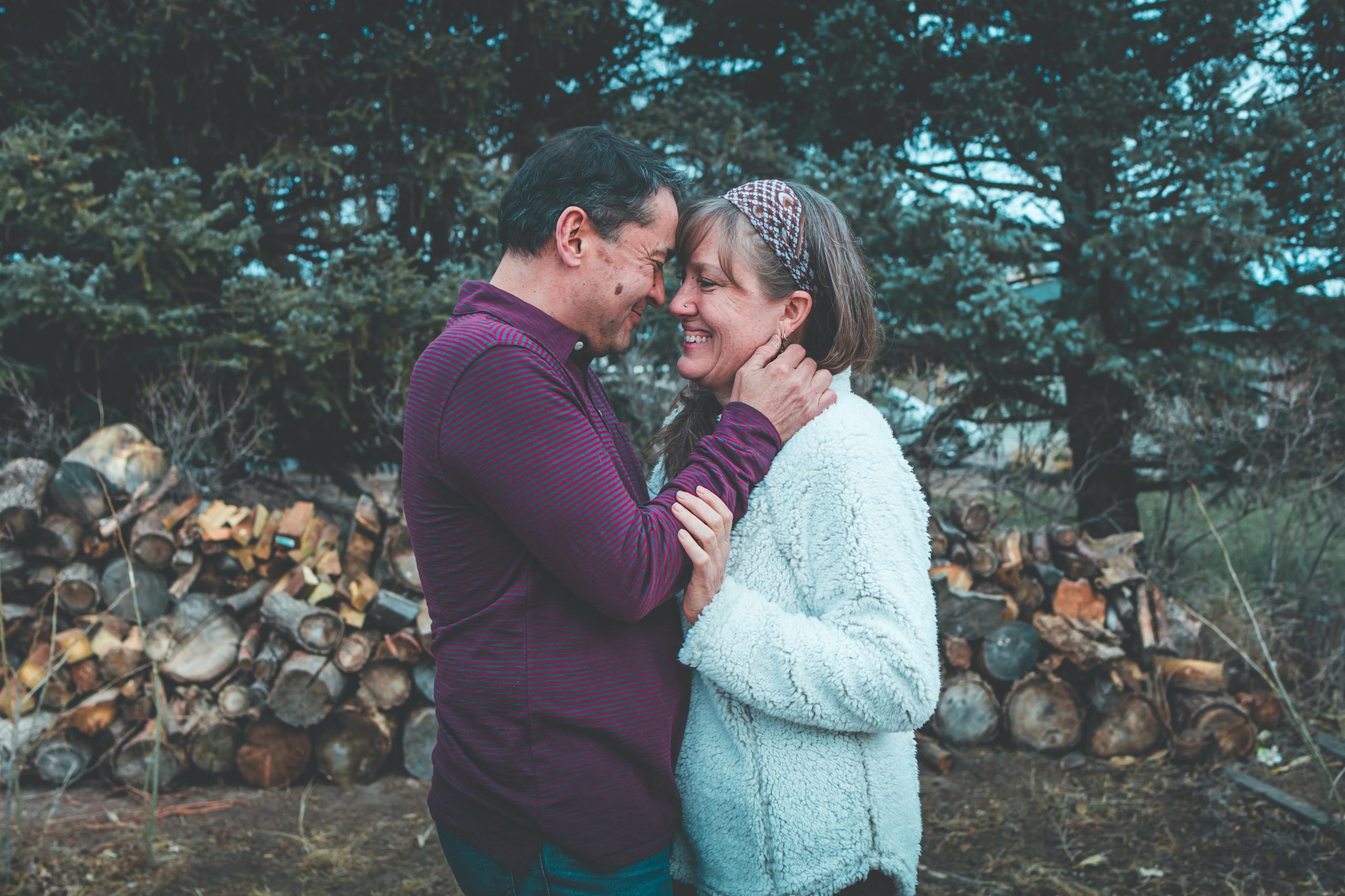 A couple holding one another outside.