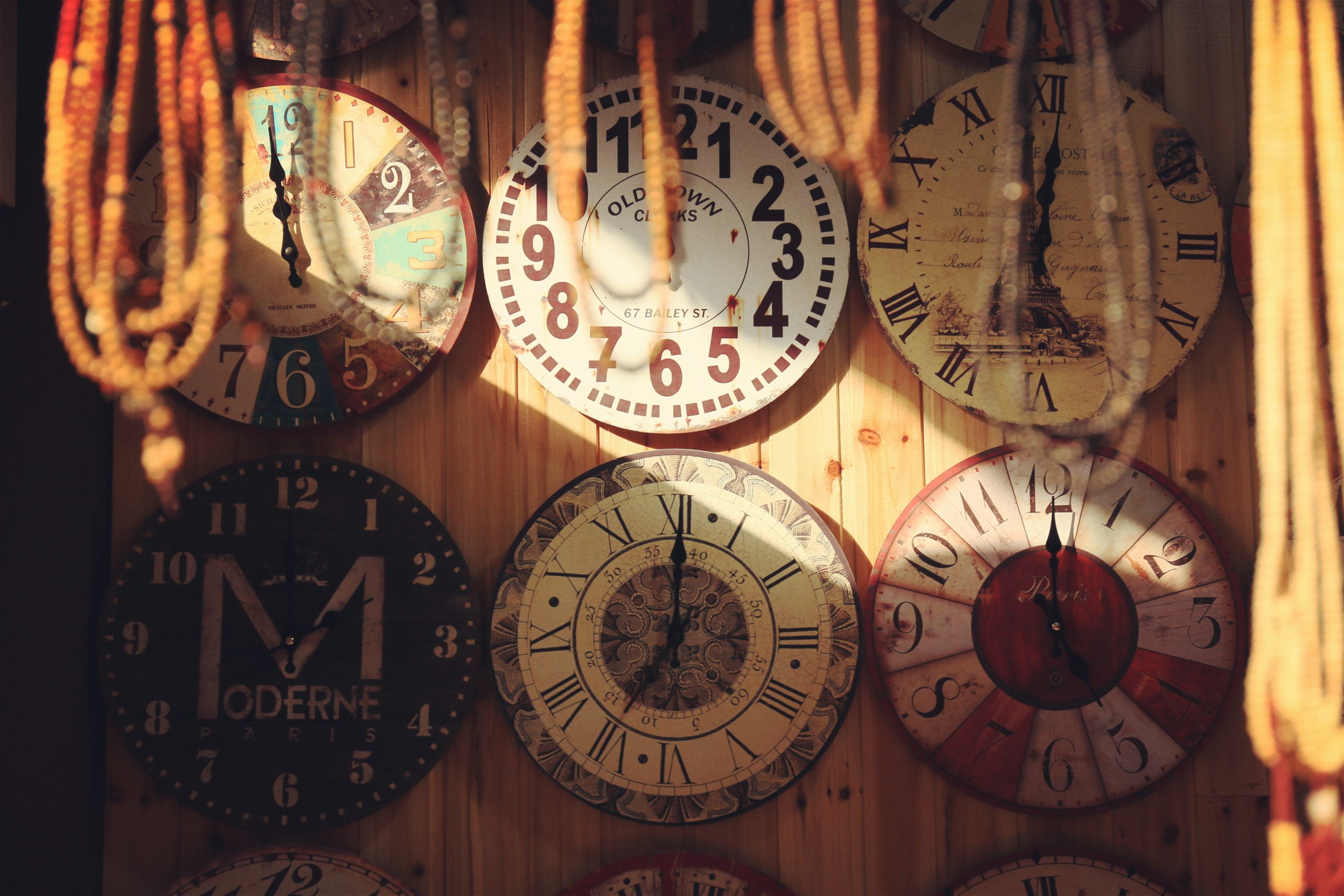 A wall of vintage clocks.