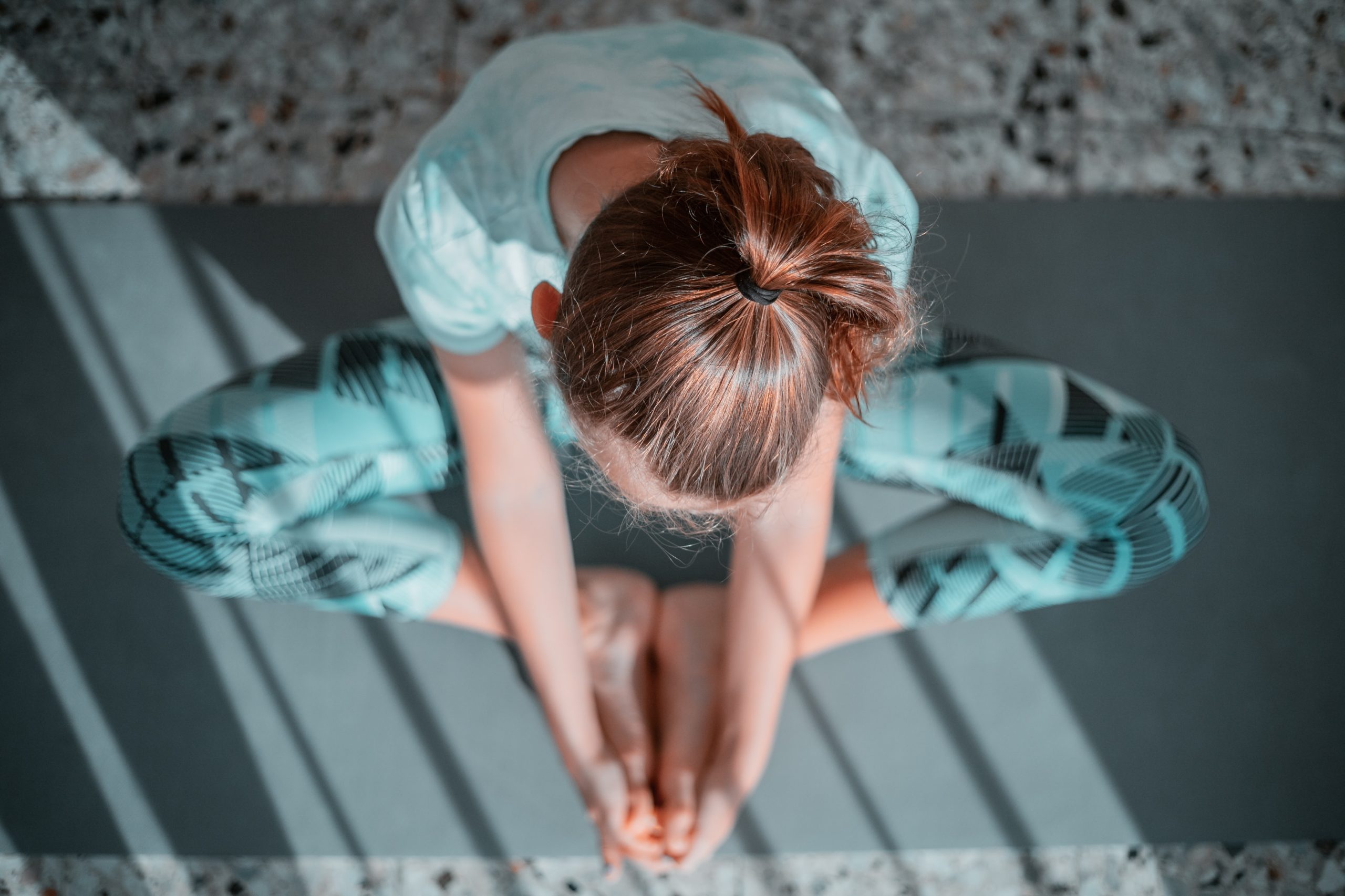 A woman in a yoga pose as seen from above.