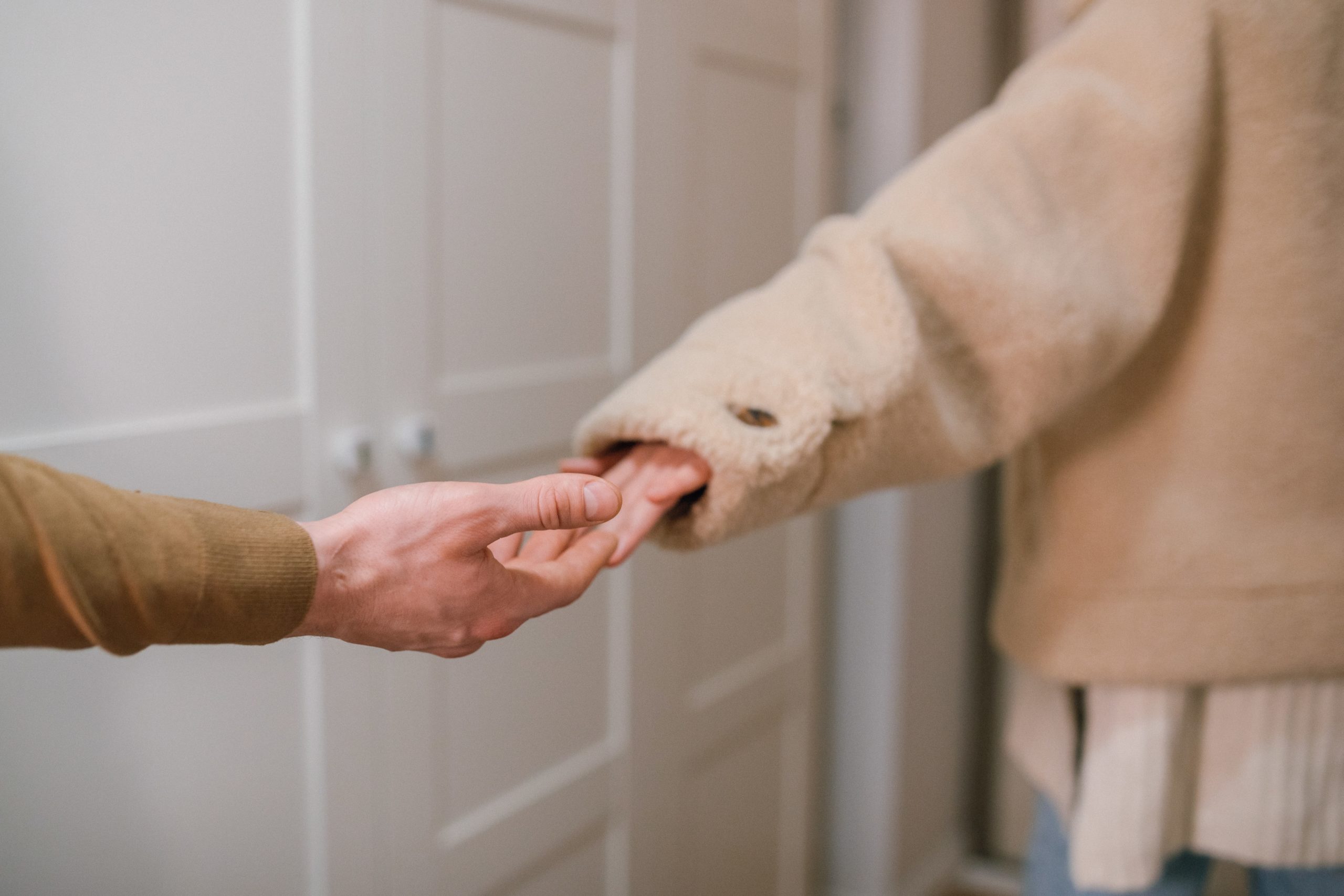 A woman letting go of a man's hand.