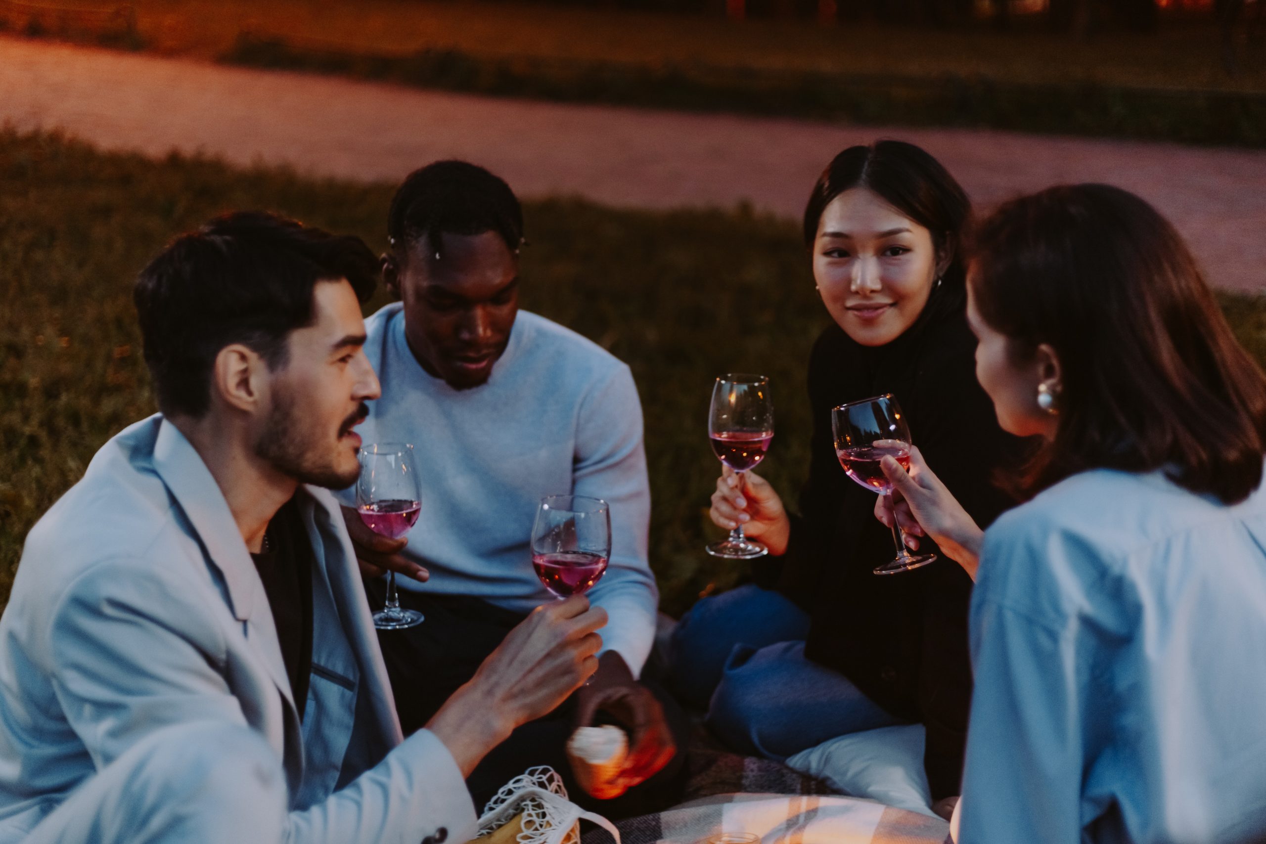 A group of friends smiling, holding wine glasses.