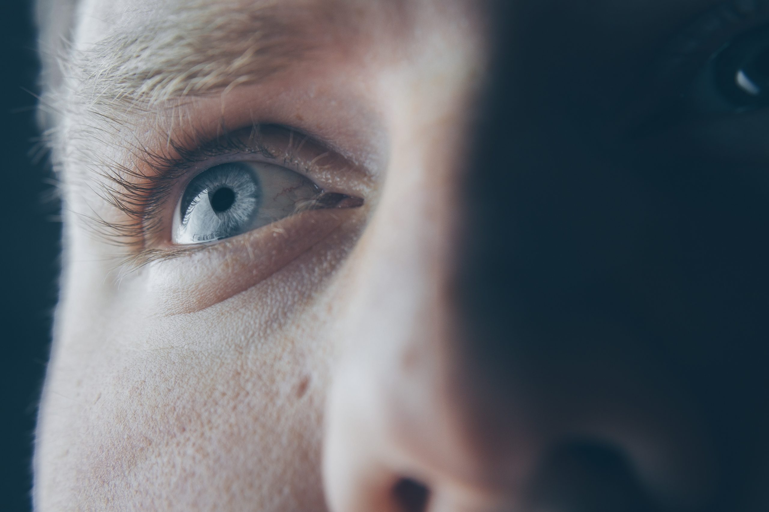 A dramatic shot of someone's eyes and nose from a low angle.