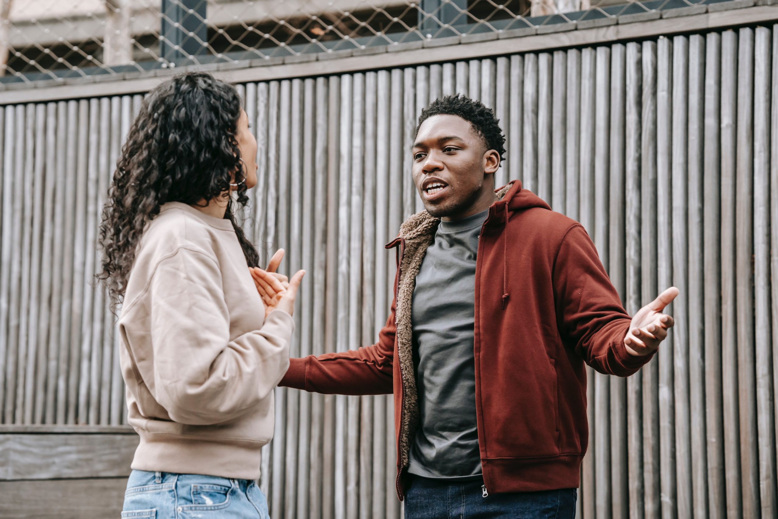 A couple arguing outside.