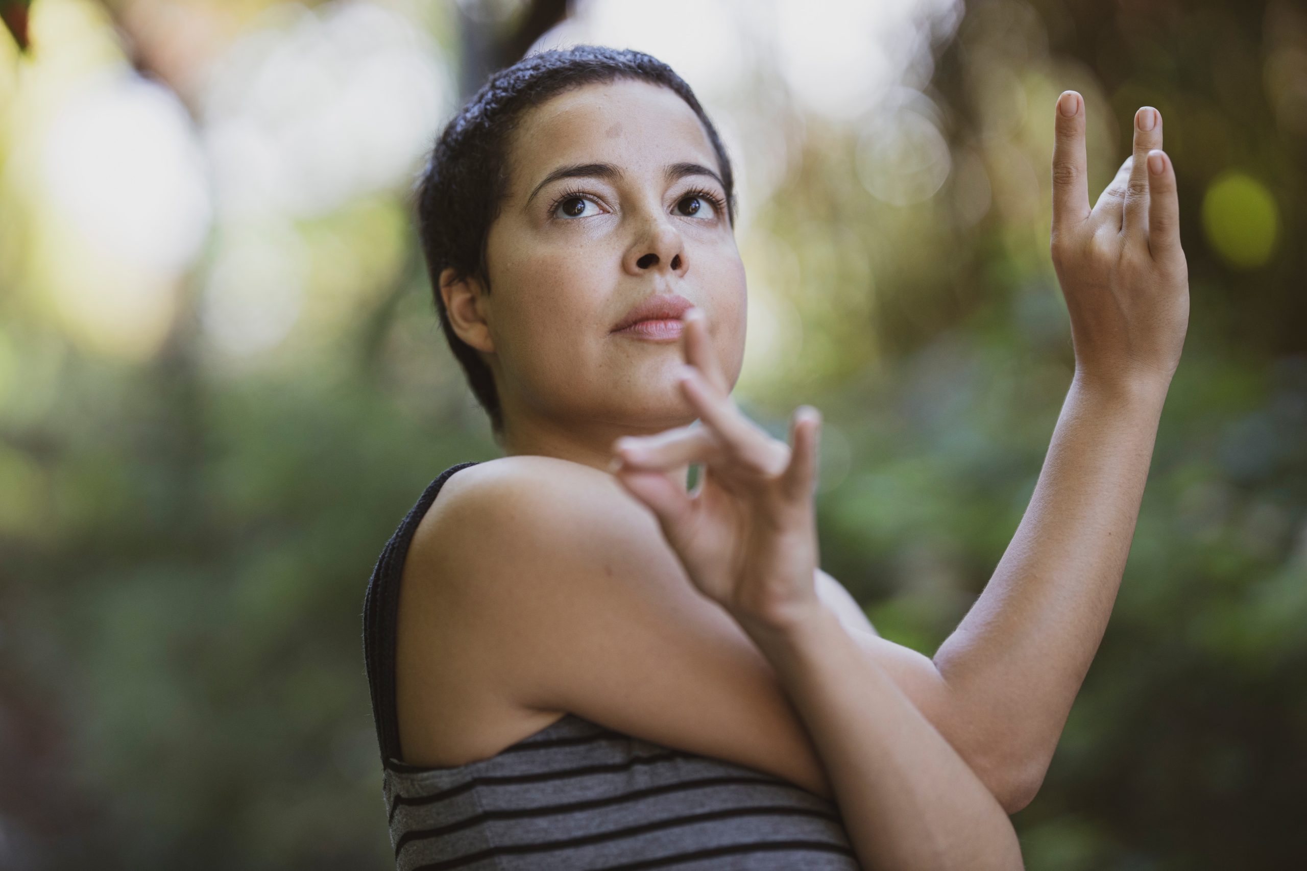 A woman meditating with poised hands.