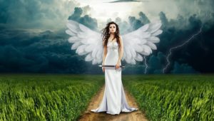woman stands in thunder storm in field with angel wings