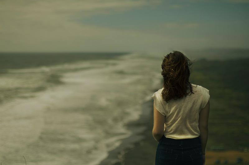 woman standing to face the waves