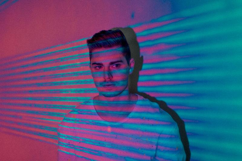 man in pink and blue lighting