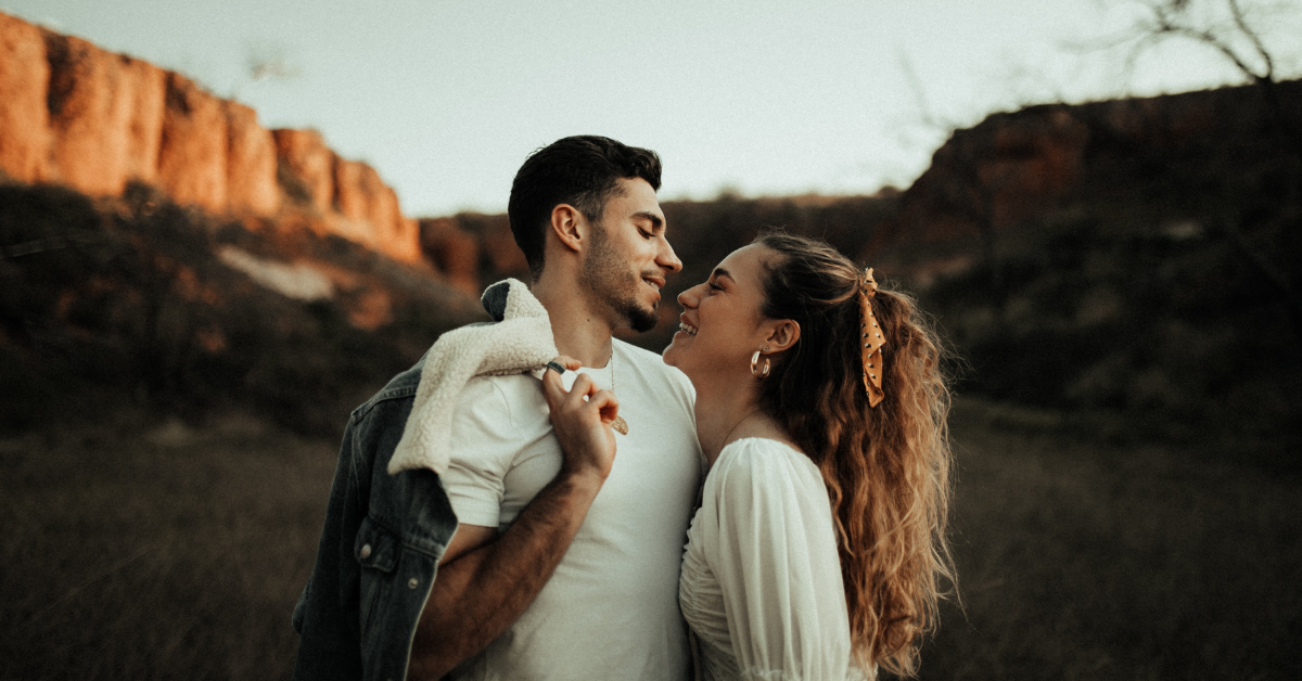 woman looks up to man smiling