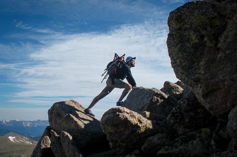 man climbing rocks