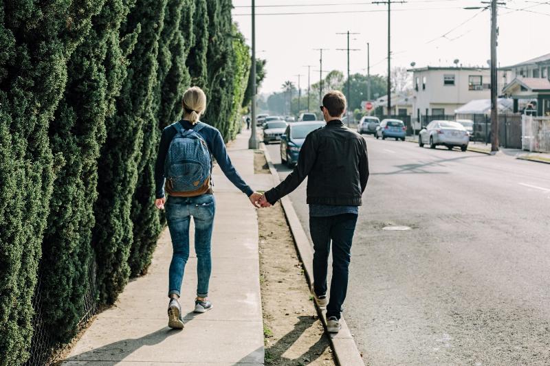 man and woman walk on street