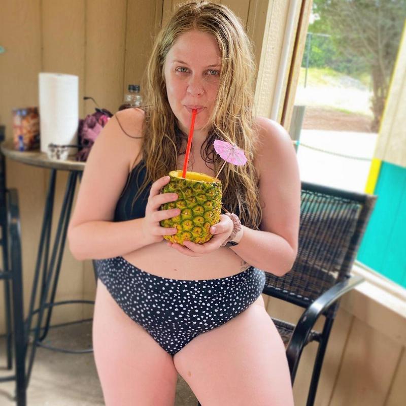 cassidy holds pineapple drink
