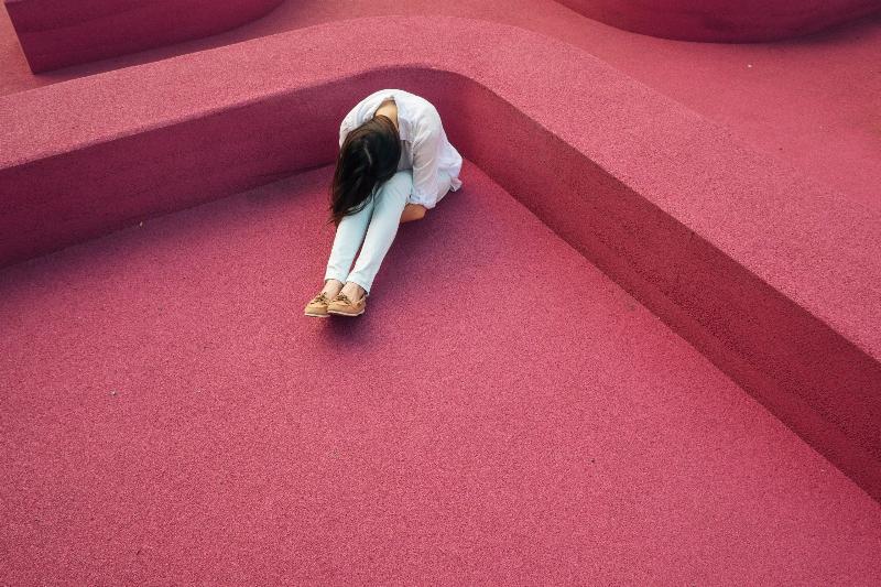 woman sitting on pink ground