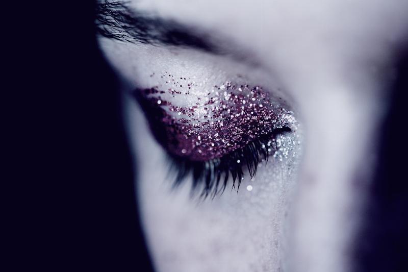 woman with eye full of glitter shut