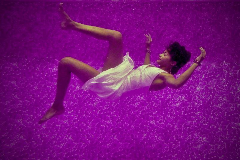 woman falling in pink water