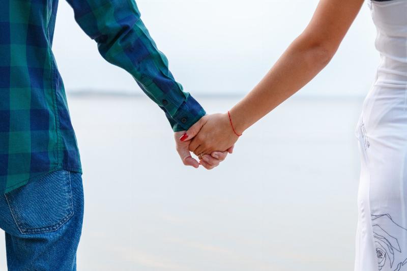 close of man and woman holding hands