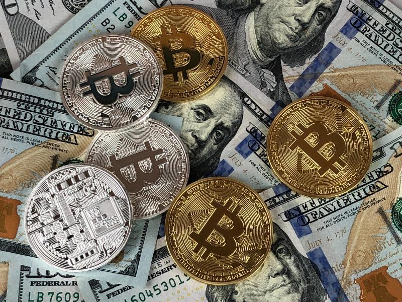 dollar bills and bitcoin close up