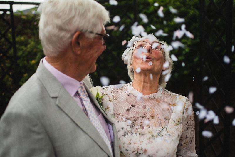 elderly couple smiling and dressed up and looking in love