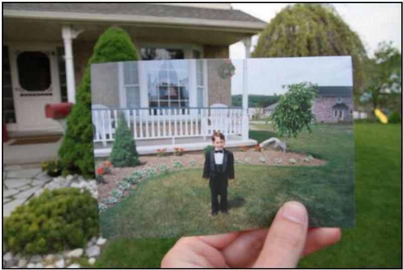 hand holds picture of kid in the front yard