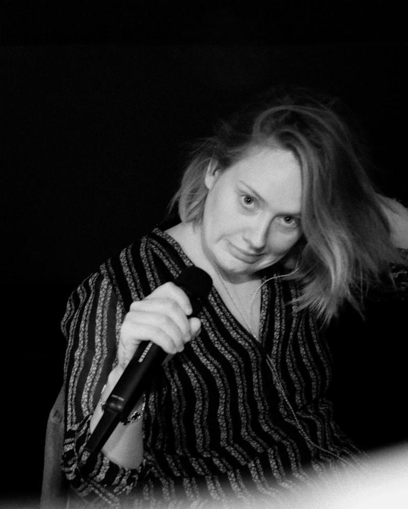 black and white photo of adele without makeup holding a mic in Houston, TX at Toyota Center on Nov 9 2016