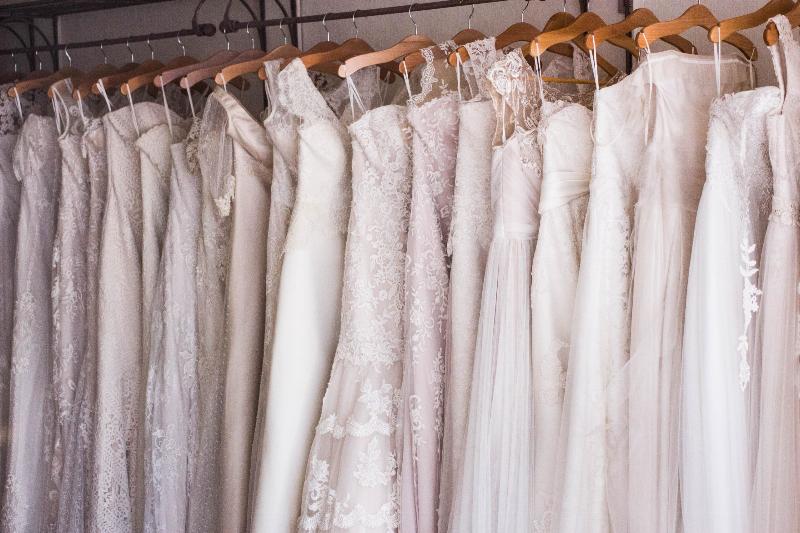 wedding gowns hung up on rack