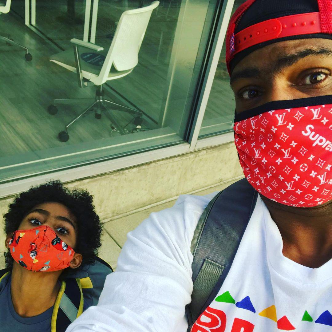 Bear and son take selfie in the city with red masks on