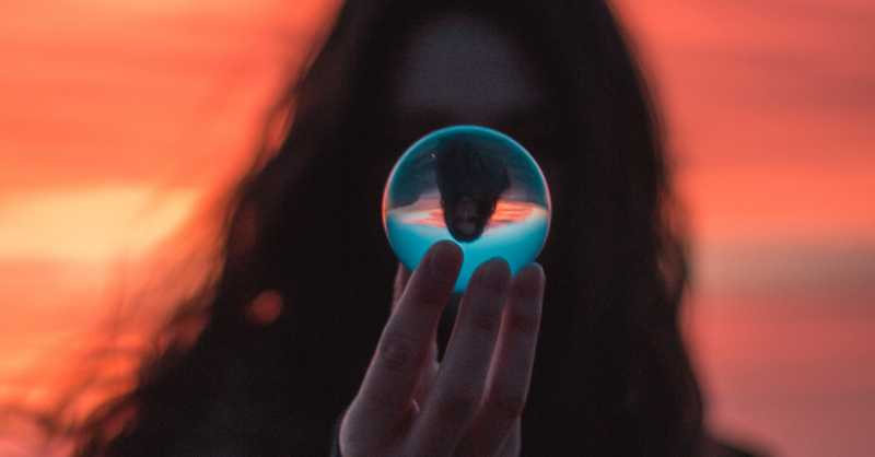 woman holding up bubble in her hand