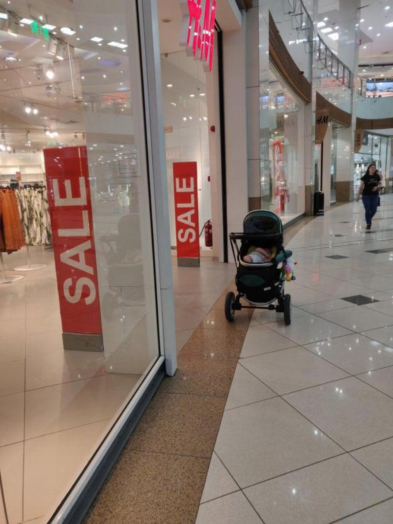 baby stroller infront of mall stroller unattended