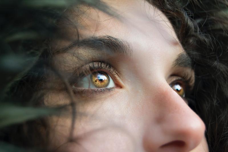 close up of woman with brow eyes looking forward