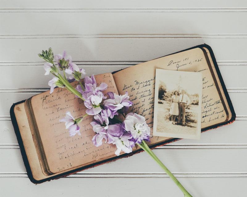 journal with black and white photo and bouquet on top