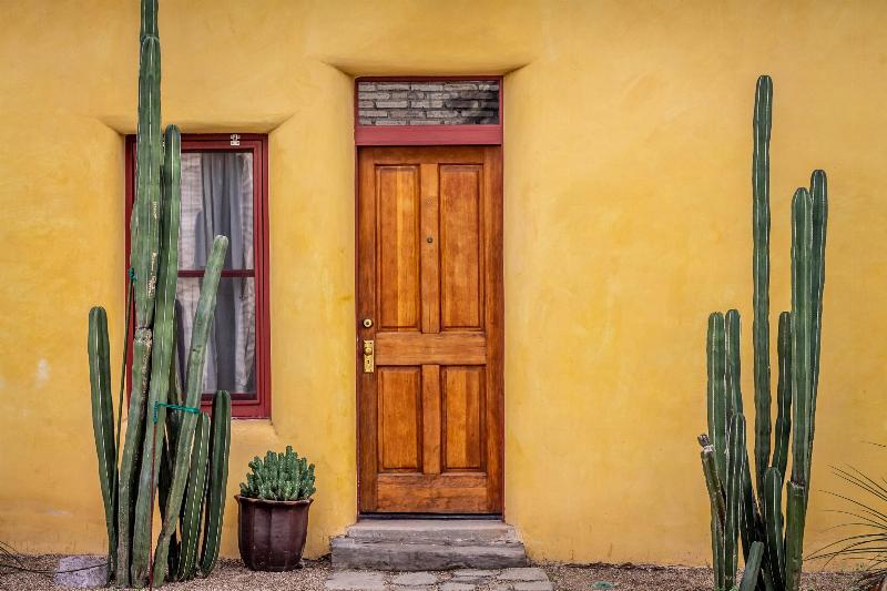 brown wooden door in yellow texas hourse