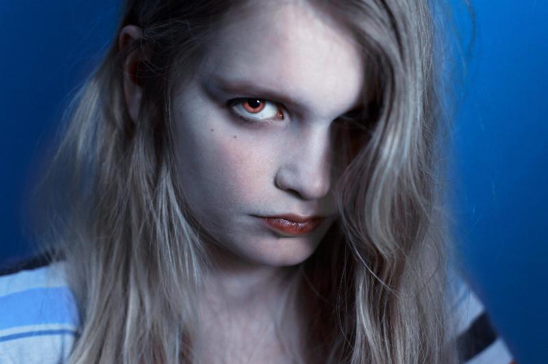 blond woman with vampire eyes