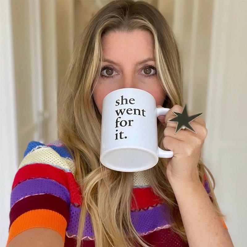 Sarah drinking out of her mug that says 
