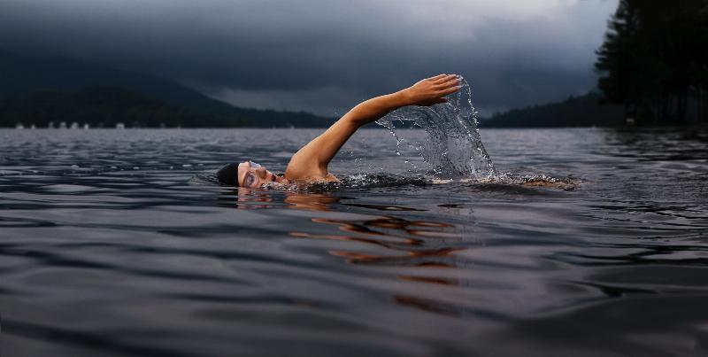 man swimming stroke in ocean water