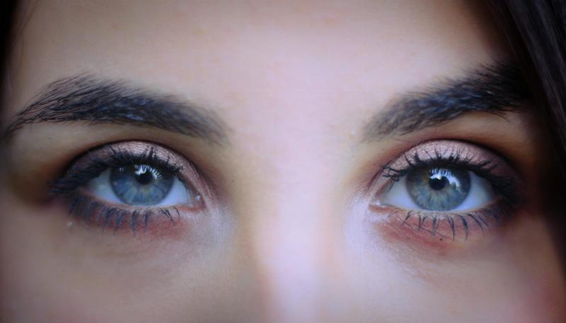 close of woman's blue eyes with makeup