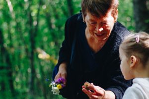 grandma showing kid how to garden