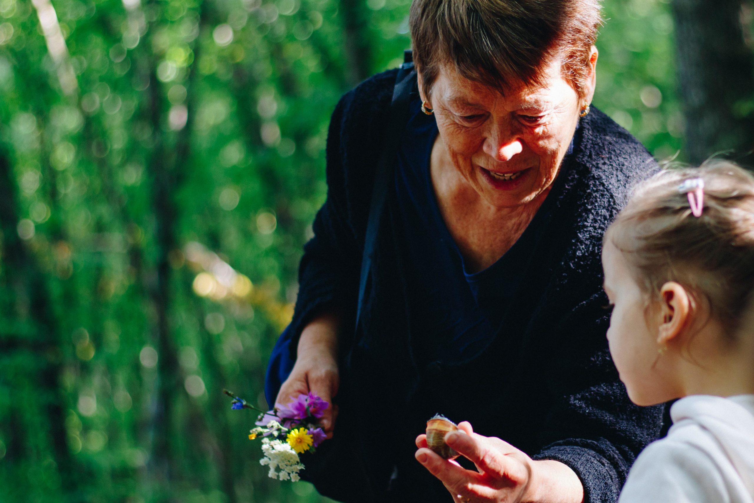 grandma showing kid how to garden